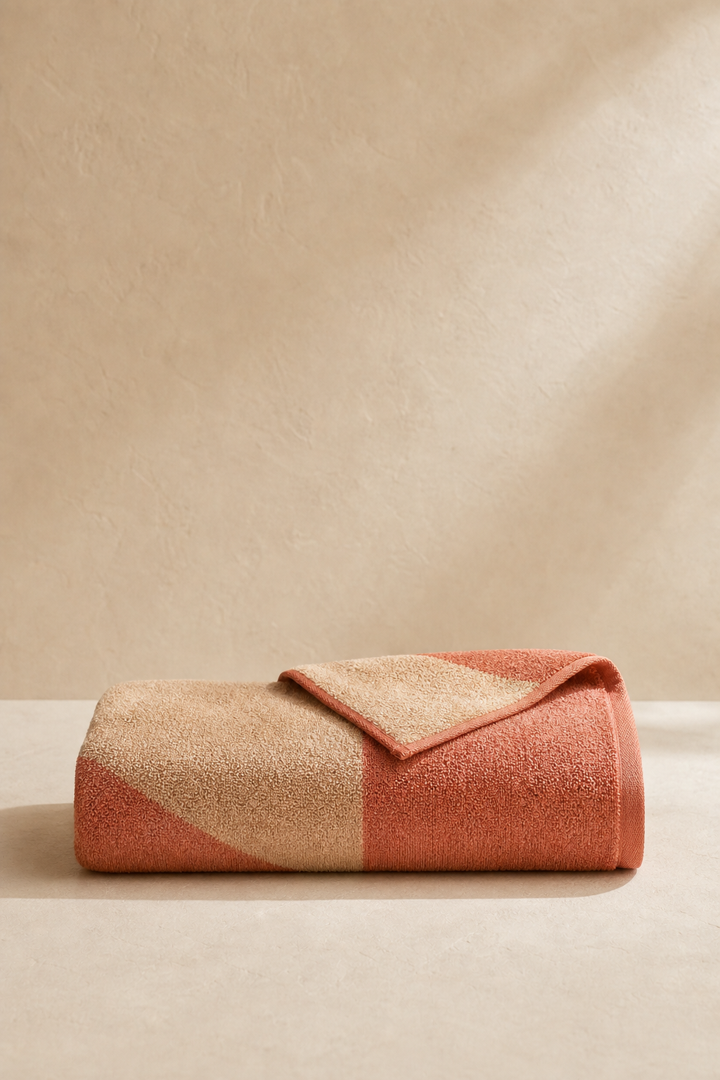Sun Terrace Beach Towel folded as one continuous clay and sand towel
