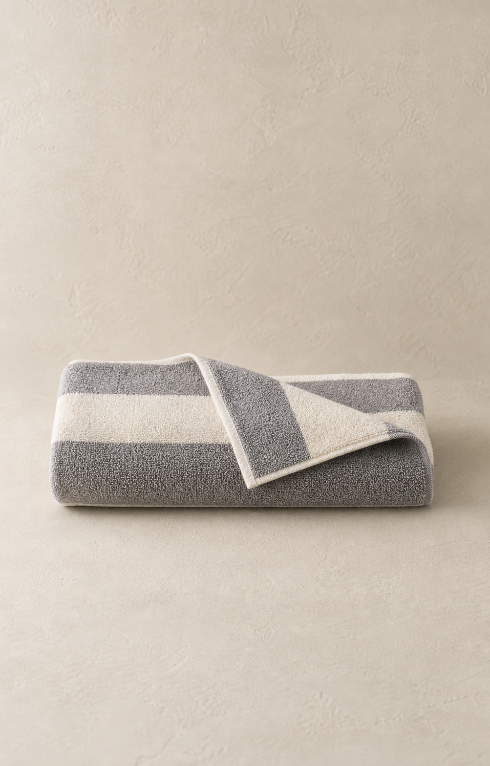 Tide Stripe Beach Towel folded as one continuous striped cotton towel
